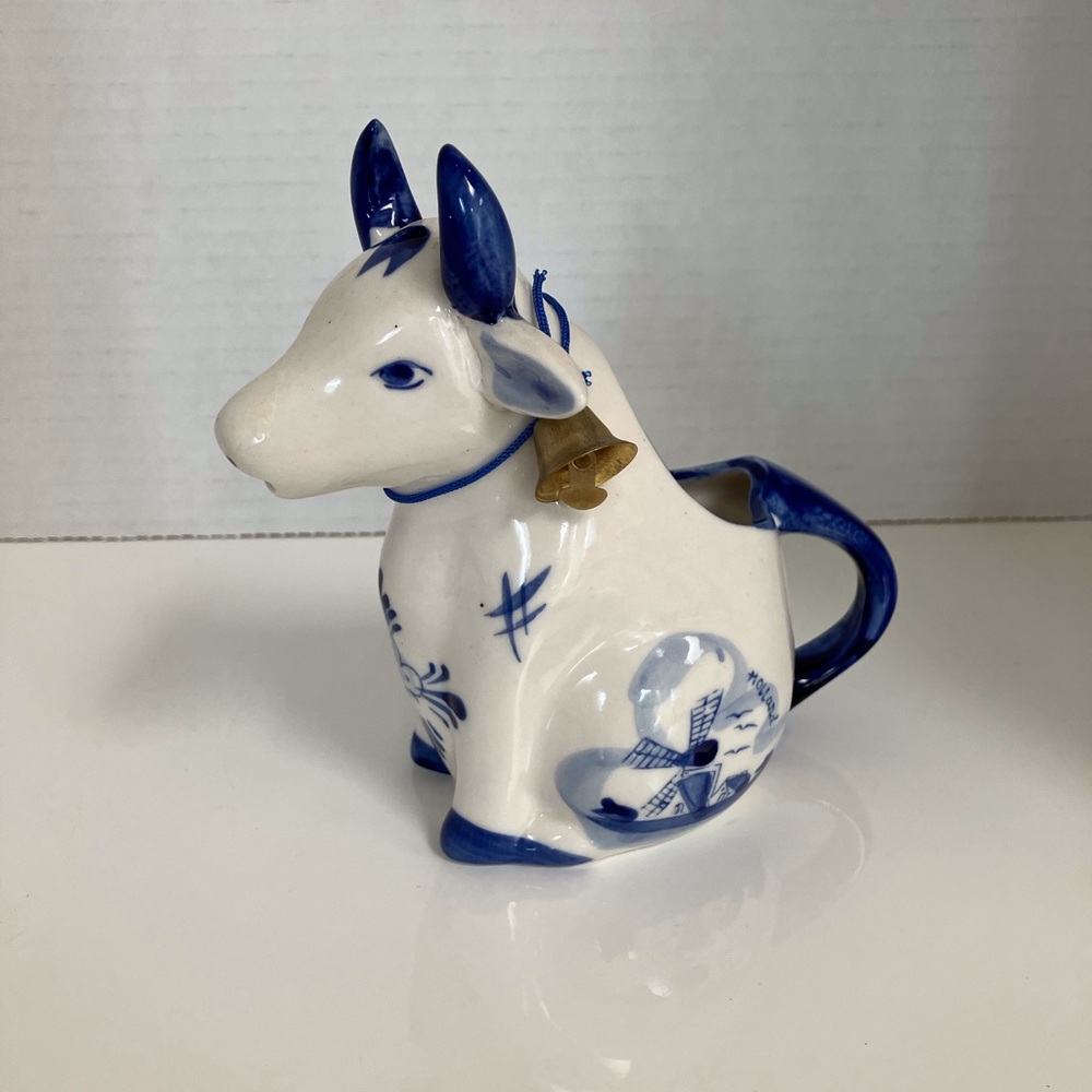 Vintage Delft Blue sitting cow creamer with hand painted designs